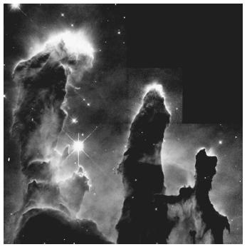 A star-forming region: pillars of gas in the Eagle Nebula (M16). A molecular cloud is eroded by the winds and radiation of nearby very bright stars (not shown, top right in figure), leaving these columns of denser and more resistant gas. Star formation is occurring in very dense globules of gas, some of which can be seen around the periphery of the pillars.