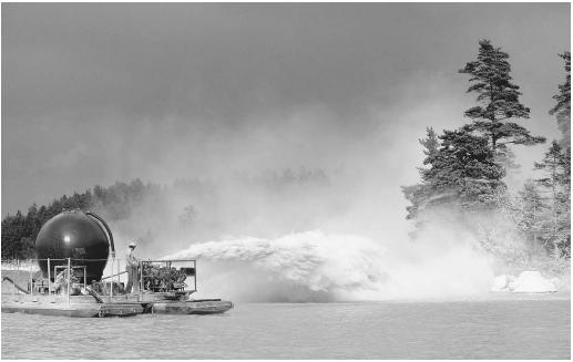 This worker is spraying a lake in Sweden with agricultural lime (calcium oxide), in an attempt to counteract the inflow of acidic materials.