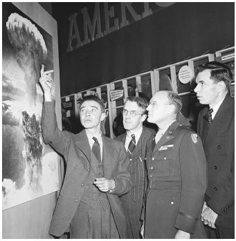 From left: J. Robert Oppenheimer, Professor. H. D. Smythe, General Nichols, and Glen Seaborg in 1946 looking at a photograph of the atomic blast at Hiroshima. The atomic bomb was developed in the Manhattan Project.