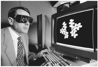 Michael Chaney of Lilly Research Labs wearing 3-D glasses to view a computer model of Fluoxetine, or Prozac. The glasses dim and brighten in response to the flashing of the computer monitor.