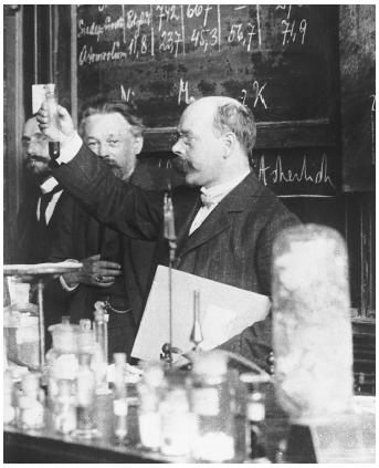 German chemist and physicist Walther Hermann Nernst (front holding vial), recipient of the 1920 Nobel Prize in chemistry, "in recognition of his work in thermochemistry."