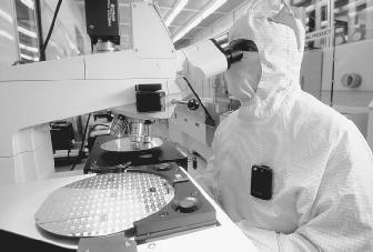A worker is testing silicon wafers at the Matsushita Semiconductor plant in Puyallup, Washington. Semiconductors are used in many different electronic products, such as computers, lasers, and solar panels.